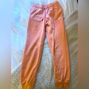 Nike Sweatpants size small. Orangey pink color.